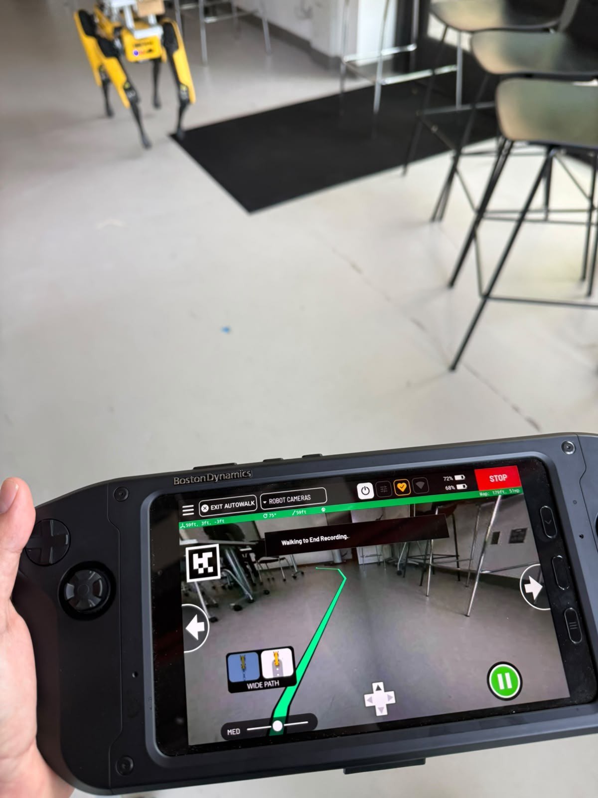 Recording an autonomous inspection route: the prototype ahead, the operator&rsquo;s controller showing its camera view and the route